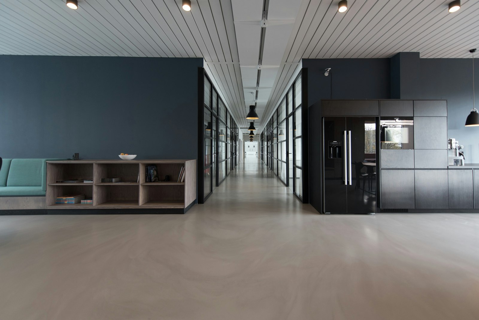 A quiet, minimal office corridor with wooden floors
